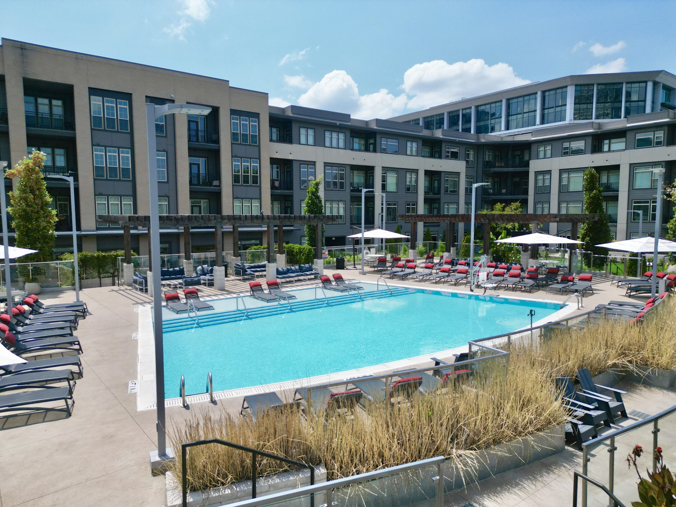 Residences at capitol view resort style pool amenity with ample seating around the pool and a view of the city in the background